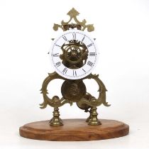 A brass skeleton clock, having an unsigned white enamel Roman dial, eight-day chain-driven fusse