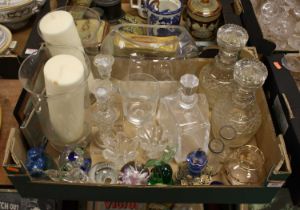 A collection of glassware to include a pair of glass decanters and paperweights