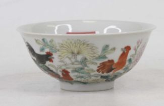 A Chinese porcelain bowl, enamel decorated with cockerels amongst flowers, bearing six character