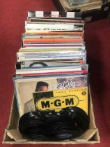 A collection of vintage LPs and singles to include Bobby Brown, Eddie Grant, and Whitney Houston