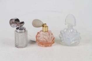 A French frosted pressed glass scent bottle, of shell shape, h.11cm; together with two atomisers