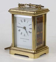 A 20th century lacquered brass carriage clock, having visible platform escapement, the white