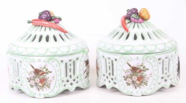 A pair of porcelain pot pourri, each relief decorated with fruit to the handle, h.17cm These are