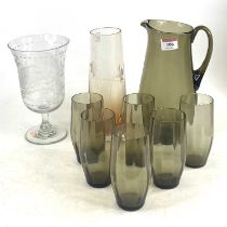 A 20th century smoky glass six-place lemonade set; together with a floral etched; and one other, the