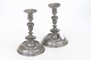 A pair of 19th century pewter table candlesticks, each having circular sconce on knopped support and