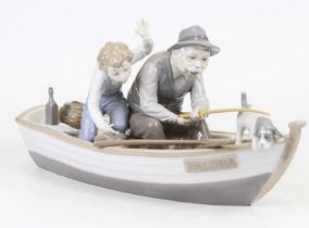 A Lladro porcelain figure group of a gentleman and a boy fishing, length 39cm The tip of the rod