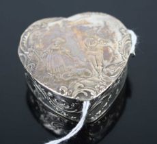 A continental silver heart shaped pill box, having embossed hinged cover, with London import marks