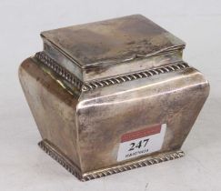 A George V silver tea canister of shouldered baluster form with gadrooned decoration, hinge cover,