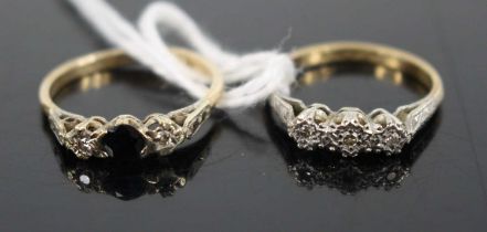 An 18ct gold and platinum diamond three-stone ring, arranged as three small illusion set round cuts,