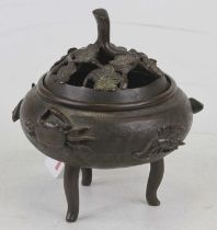 A Japanese late Meiji Period (1868-1912) bronze koro and cover, the pierced lid in the form of