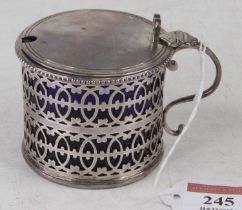 A George V silver lidded mustard 3.3oz, having blue glass liner London 1916 height 6.5cm