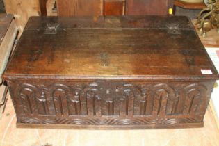 An 18th century carved oak Bible box, having a hinged lid, with some later elements, w.64cm