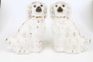 A pair of Victorian Staffordshire pottery models of spaniels, each h.28cm