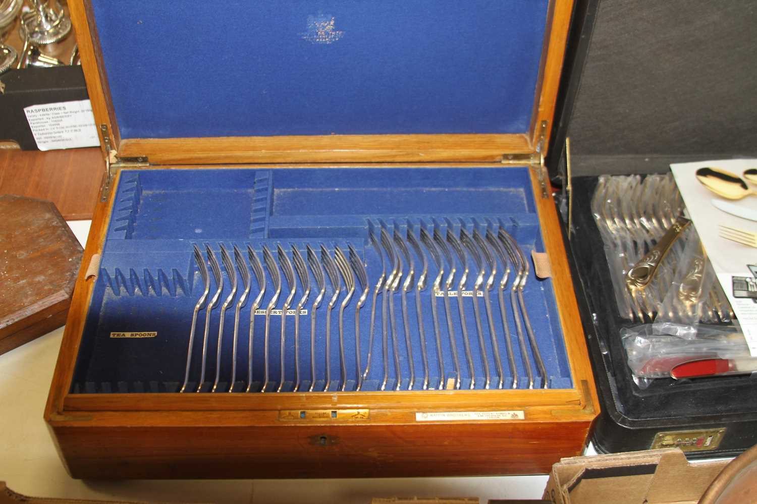 An early 20th century oak cased part canteen of silver plated cutlery, mostly in the Fiddle pattern,
