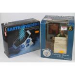 A Wallace & Gromit boxed talking alarm clock and an Earth Invaders computer space battle game in