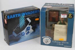 A Wallace & Gromit boxed talking alarm clock and an Earth Invaders computer space battle game in