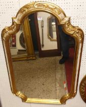 A contemporary floral gilt white painted and shaped wall mirror in the French taste, 98 x 66cm,