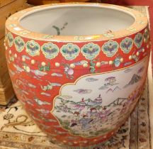 An unusually large Chinese enamel decorated stoneware fish bowl, of slightly bulbous form, the