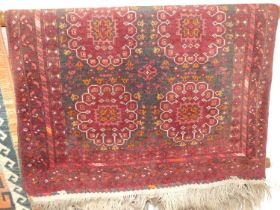 A Persian woollen red ground Bokhara rug, 130 x 96cm