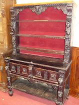 An early 20th century ebonised and relief carved oak dresser in the Jacobean taste, having three-