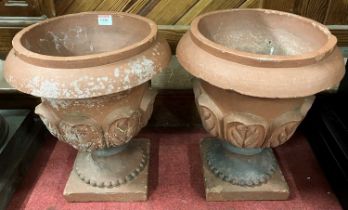 A pair of small terracotta footed circular planters, with raised outer leaf decoration, dia. 31.5cm,