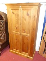 A modern pine double door wardrobe, having interior hanging rail, width 108.5cm