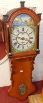 A late 19th century French provincial oak hanging vineyard clock, with painted arch dial and