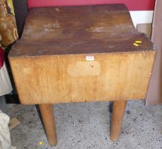 An early 20th century Canadian maple square butcher's block, raised on cylindrical turned and