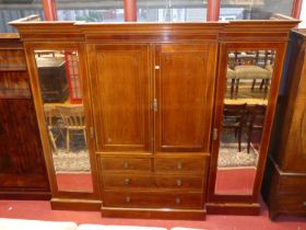 An Edwardian mahogany and chequer strung breakfront gentleman's wardrobe, the twin central panel