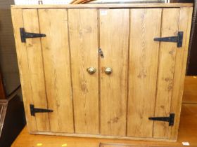 A rustic boarded pine double door hanging wall cupboard with exposed iron hinges, 70 x 81.5cm