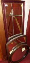 An oak framed and bevelled oval wall mirror; together with two others (3)