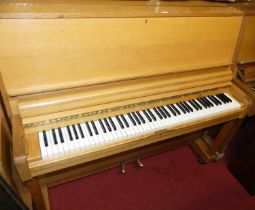 A hardwood cased upright piano by Danemann, iron framed and overstrung, width 143cm