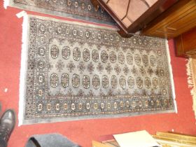 Three various similar Persian woollen blue ground Bokhara rugs, the largest 185 x 129cm All three in