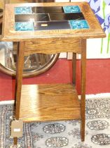 An early 20th century oak and tile-top inset two-tier occasional table, w.41.5cm Woodworm marks