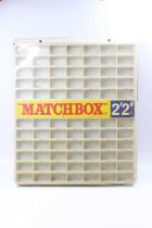 A Matchbox Lesney 1-75 miniature retailers shop display case, display has 77 model compartments,