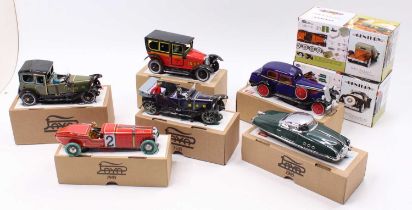 A collection of boxed Paya tinplate clockwork veteran cars, and Testors Turn Of The Century model