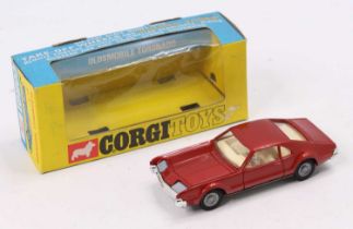 Corgi Toys No. 276 Oldsmobile Toronado comprising of metallic red body with cream interior, with