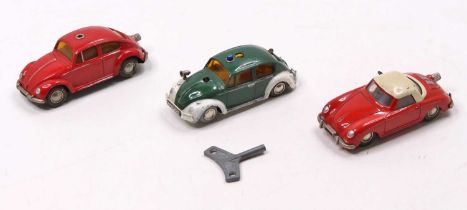 A collection of three carious Schuco tinplate and clockwork vehicles to include a No.1046 Volkswagen