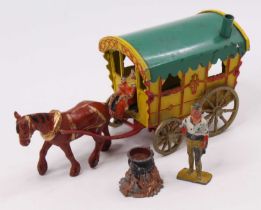 A Morestone lead hollow cast gypsy caravan, comprising of yellow and red body with green roof with