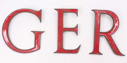 Three various brass and enamelled advertising letters to read GER, red example, the largest is