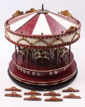 A very well constructed electrically operated model carousel, finished in maroon with gold banding