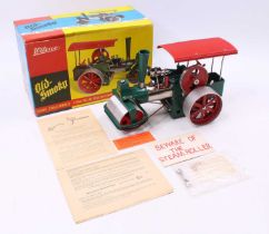 A Wilesco E36 Old Smoky spirit fired steam roller comprising of green and red body housed in the