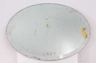 An original LNER oval mirror with bevelled edge, does require cleaning, measures 40cm x 29cm