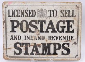 An original tin "Licenced to sell Postage and Inland Revenue stamps" wall sign, black on white