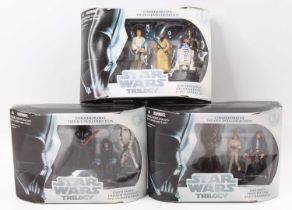A collection of three Star Wars Trilogy Hasbro triple packs/commemorative trilogy DVD collection