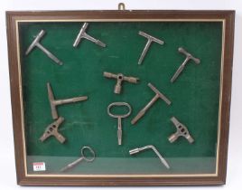 A framed and glazed display of various vintage mixed region railway carriage keys to include LNWR,