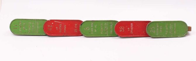 A collection of five wooden mounted cast lever plate numbers, red and green examples, reading No. 25