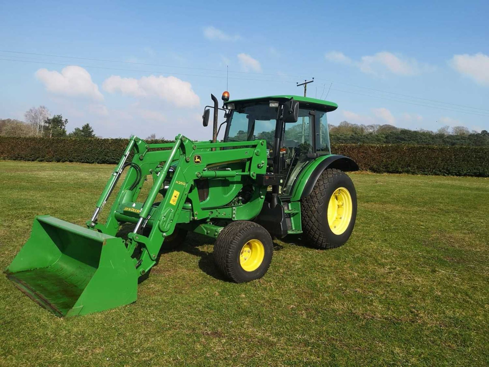 John Deere 5070M tractor with loader. Comes with bucket and tines. Low hours (1,609 hours) (Year /