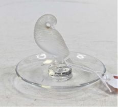 A Lalique moulded glass pin tray, surmounted by a frosted glass turtle dove, signed to the