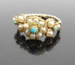 A vintage yellow metal seed pearl and turquoise set dress ring as a flower head setting to a rope
